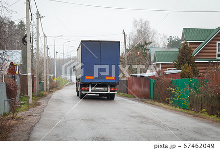 Lorry goes on empty rural road at day Lorry goes on empty rural road at day 67462049