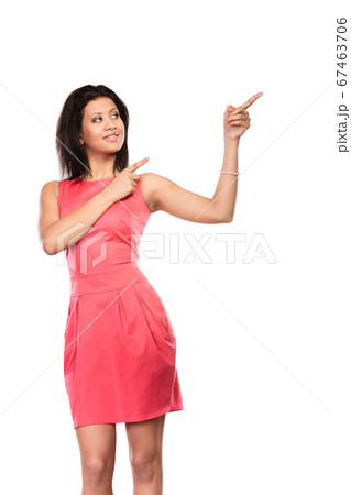Pretty woman pointing at empty blank copy space. 67463706