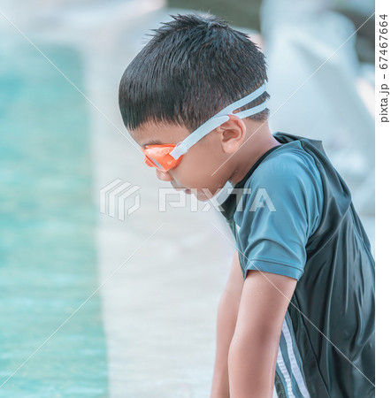Little boy with swimming goggles and swim suit is 67467664