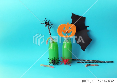 Happy Halloween, bottles with green cocktail, mystical decor on a bright background 67467832