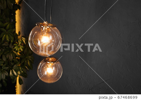 Decorative light tungsten bulbs against wall background Decorative light tungsten bulbs against wall background 67468699