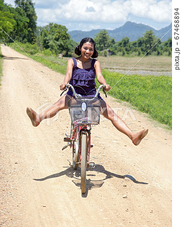cheerful girl goes on a bicycle at Laos cheerful girl goes on a bicycle at Laos 67468894