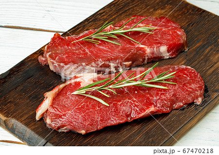 Barbecue veal steaks with rosemary on wooden board 67470218