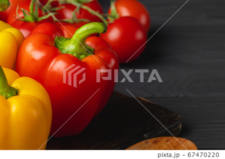 Cherry tomatoes and bell pepper on kitchen table 67470220