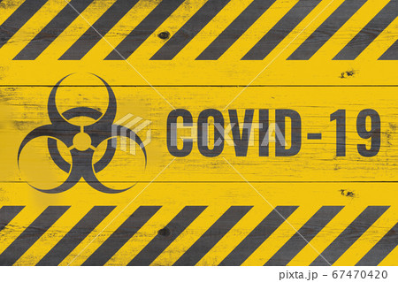 bio hazard sign and covid-19 message on aged gray bio hazard sign and covid-19 message on aged gray 67470420