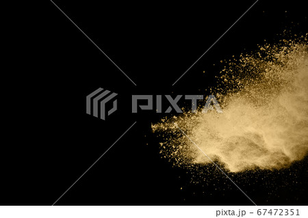 Golden powder explosion on black background. Freeze motion. Golden powder explosion on black background. Freeze motion. 67472351