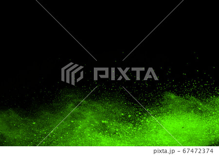 The movement of abstract dust explosion frozen green on black background. Stop the movement of powdered green on black background. Explosive powder green on black background. The movement of abstract dust explosion frozen green on black background. Stop the movement of powdered green on black background. Explosive powder green on black background. 67472374
