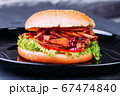 Fresh burger over wooden table and dark background. Front view 67474840