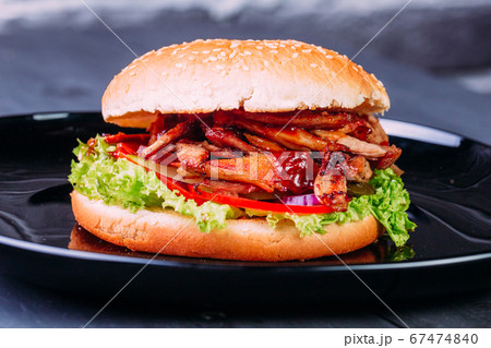 Fresh burger over wooden table and dark background. Front view 67474840
