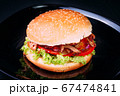 Fresh burger over wooden table and dark background. Front view 67474841