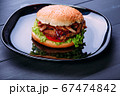 Fresh burger over wooden table and dark background. Front view 67474842