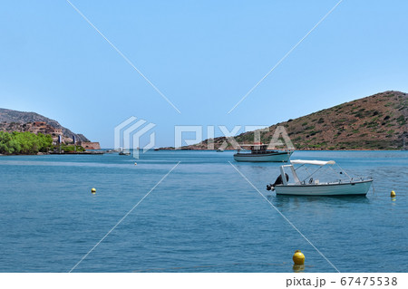 View of lagoon with anchored fishermen's boats on a sunny summer day on Crete island, Greece View of lagoon with anchored fishermen's boats on a sunny summer day on Crete island, Greece 67475538