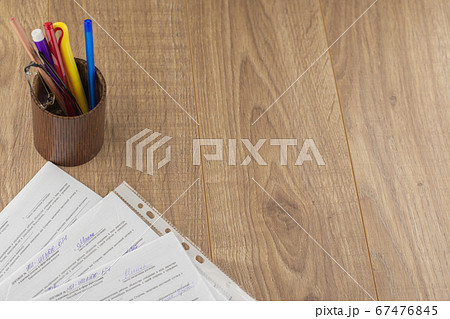 workplace of the businessman: some forms of contracts, filled and empty, and stationery in the pencil case, the space to the right 67476845