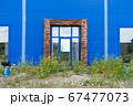 overgrown entrance to an abandoned shopping center building 67477073
