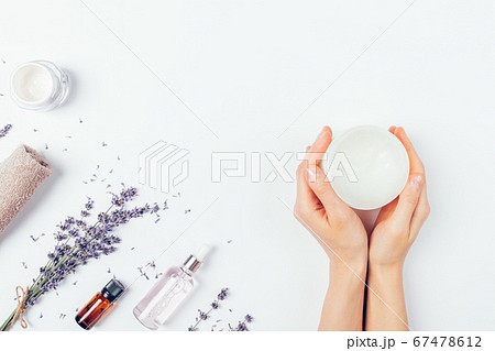 Top view woman's hands holding jar soothing cream Top view woman's hands holding jar soothing cream 67478612