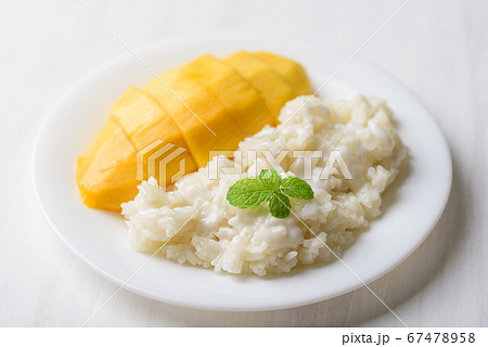 Mango sticky rice on plate with white table, Thai dessert (Khao Niew Ma Muang) 67478958