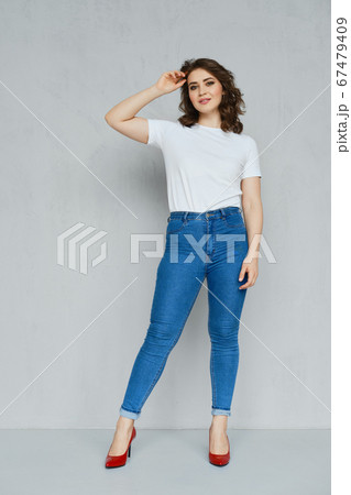 Positive girl in jeans, t-shirt and stilettos 67479409