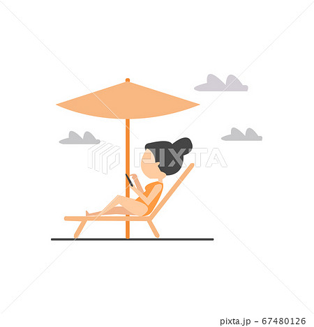 Woman lying on the lounger at the beach and checking her phone 67480126
