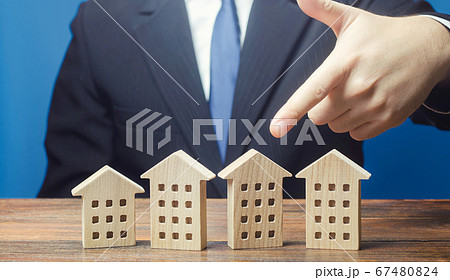A man chooses an apartment house among many propositions options in the real estate market. Housing solution. Facilities and infrastructure. Investments. Realtor services to find suitable options. A man chooses an apartment house among many propositions options in the real estate market. Housing solution. Facilities and infrastructure. Investments. Realtor services to find suitable options. 67480824