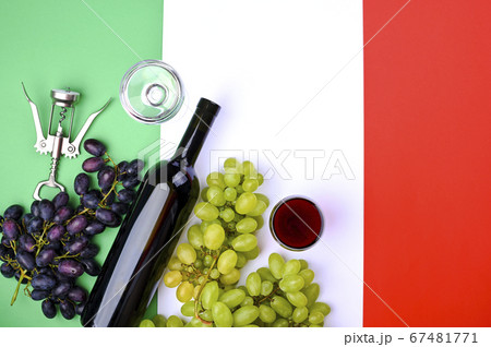 Wine, grape, glass of wine and flag of Italy close up. Country symbol backdrop. The concept of Wine, grape, glass of wine and flag of Italy close up. Country symbol backdrop. The concept of 67481771