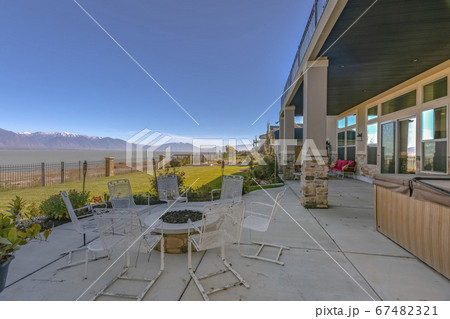 Patio with chairs around a circular fire pit Patio with chairs around a circular fire pit 67482321