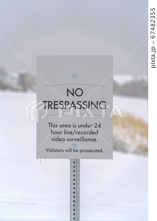 No Trespassing sign against a snowy landscape No Trespassing sign against a snowy landscape 67482355