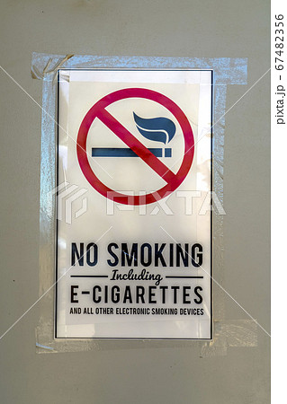 No Smoking sign taped on a gray surface No Smoking sign taped on a gray surface 67482356