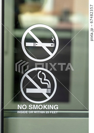 No Smoking sign on the glass window of a building No Smoking sign on the glass window of a building 67482357