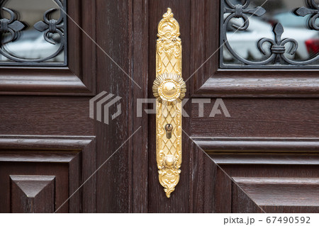 Luxurious door handle and lock on old wooden doors with glass 67490592