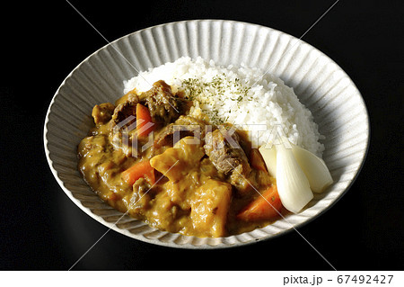 ジャガイモや人参がたくさん入った牛すじ肉入りカレーライスを黒背景で撮影 ジャガイモや人参がたくさん入った牛すじ肉入りカレーライスを黒背景で撮影 67492427
