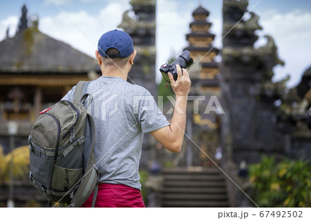 Asian photographer travel in old temple in Bali 67492502