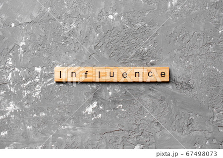 influence word written on wood block. influence 67498073