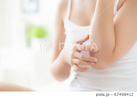 Closeup elbow of beautiful asian woman applying skincare and moisturizer cream or treatment. Closeup elbow of beautiful asian woman applying skincare and moisturizer cream or treatment. 67498412