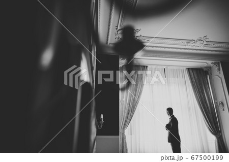 Young handsome man relaxing at his apartment in a hotel after business meeting 67500199