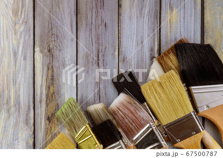 Various paint tools brush on white wooden table 67500787