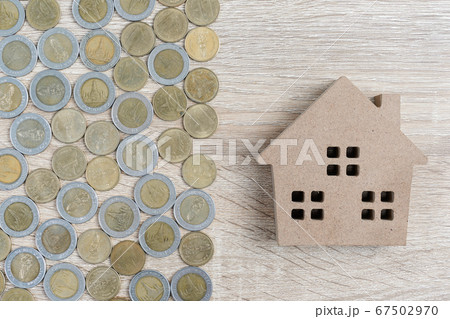 Top view house and coins on wood table 67502970