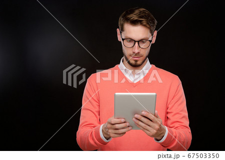 Using tablet against black background 67503350
