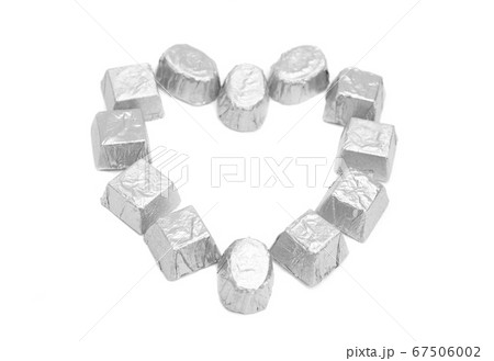 Chocolate candies in gold foil paper forming the 67506002