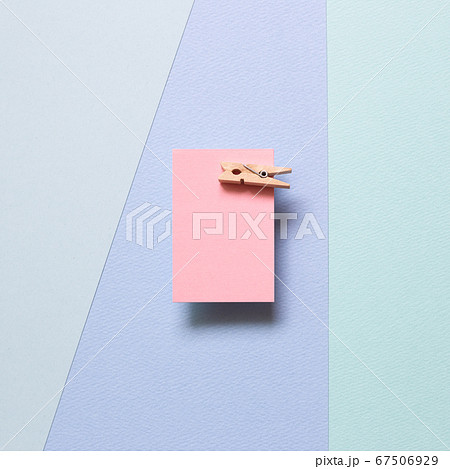 Pink memo paper, sticky notes with wooden clip on blue background. top view, copy space 67506929