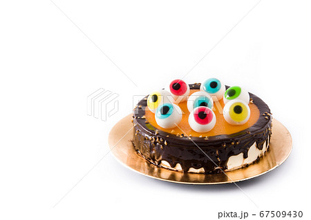 Halloween cake with candy eyes decoration isolated on white background.. Copy space Halloween cake with candy eyes decoration isolated on white background.. Copy space 67509430