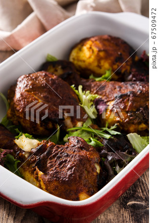 Roasted tandoori chicken on wooden table Roasted tandoori chicken on wooden table 67509472