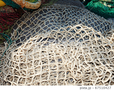 White dry fishing net with floats on pavement White dry fishing net with floats on pavement 67510427