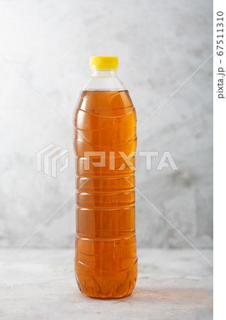 Bottle of ice tea, gray concrete background 67511310