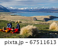 Two people laying and looking at Lake tekapo from Mount John observatory, South Island, New Zealand 67511613