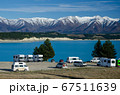 Freedom camp with campervans with blue Lake Pukaki and snow covered mountains in the background, South Island, New Zealand 67511639