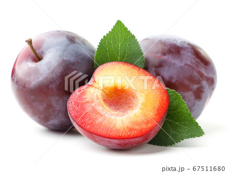 Ripe whole plums and half on a white background. Ripe whole plums and half on a white background. 67511680