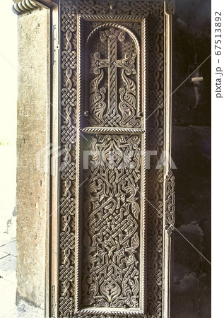 Wood cross on the front door of the Church of St. Hripsime in Echmiadzin 67513892