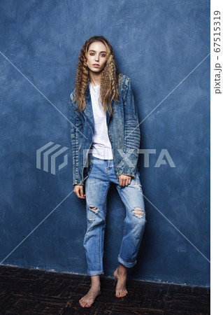 young pretty blond curly girl posing happy smiling on blue background, lifestyle people concept 67515319