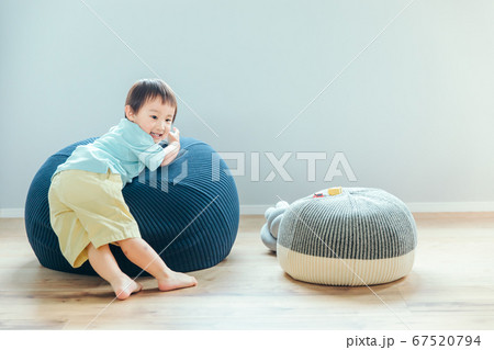部屋で男の子が大きなクッションに乗る　kids boy cushion 67520794