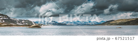 Oppland, Tyin Lake, Norway. Stones On Coast Of Beautiful Lake Tyin In Summer Cloudy Day. Norwegian Nature. panorama, panoramic view. 67521517